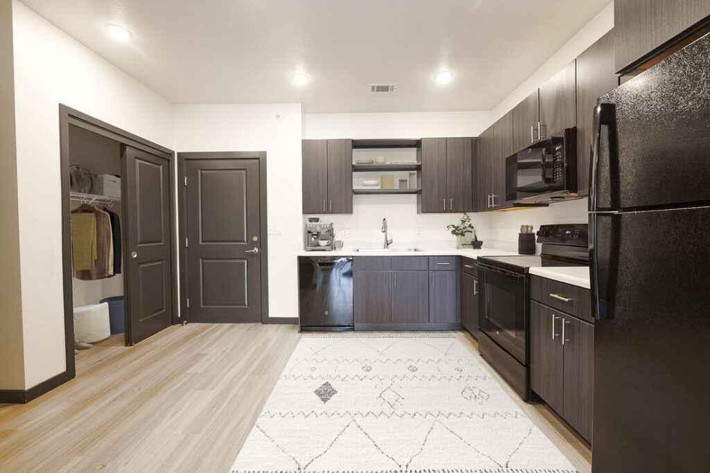 Open kitchen with black appliances
